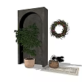 Potted Bonsai Plant With Green Leaves Near Arch Structure And Decorative Wreath