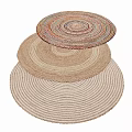 Woven Round Rugs in Neutral and Multi Colored Hues Stacked for Stylish Home Decor