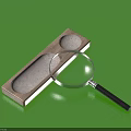 Wooden Tray With Two Circular Grooves And Magnifying Glass On Green Background