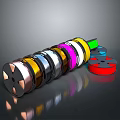 Colored Adhesive Tape Rolls In Various Shades Arranged On Reflective Surface
