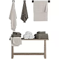 Soft Gray and White Towels Folded and Hanging on Wooden Table