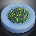 Green Grass Growing Lush Inside a Blue Recycled Tire Planter Container