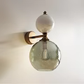 Brass Wall Lamp With White Spherical Top And Textured Transparent Glass Shade