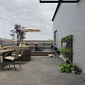 Roof Garden with Outdoor Dining Table Chairs Kitchen Counter Wooden Deck and Lush Plants