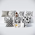 Black and White Decorative Pillows with Various Patterns and Floral Accents
