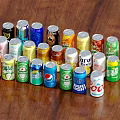Assorted Canned Beverages With Various Colors And Brands Arranged On Wooden Table