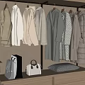Stylish Hanging White Gray Coats And Outerwear On Display Rack With Bags
