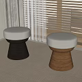 Round Upholstered Stools With Wooden Legs In Different Colors And Carpeted Room