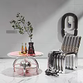 Modern Chrome Single Chair With Woven Seat And Pink Round Coffee Table With Green Plant