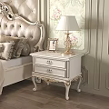 Elegant White Bedside Table With Carved Legs Gold Lamp And Photo Frame In Classic Bedroom