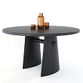 Round Black Dining Table With Unique Base Design And Decorative Brown Bottle Cups 3d model
