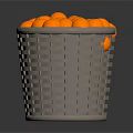 Grey Woven Basket Filled With Round Orange Decorative Balls On Dark Surface