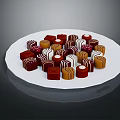 Assorted Chocolates in Red Brown White Colors and Various Shapes on White Plate