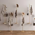 Gold Standing Coat Racks With Hats Scarves Bags Coats Against Light Wall And Wooden Floor