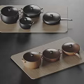 Black and Brown Cookware Set on Wooden Trays with Pots Pans and Lids