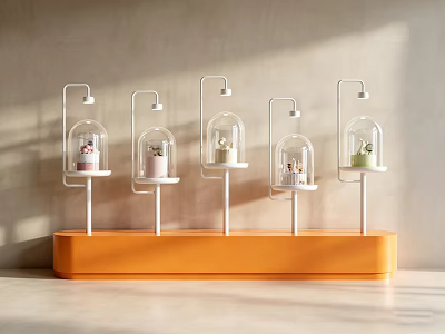 Modern Window Display With Orange Base And Five Glass Dome Stands Holding Colored Items 3d model