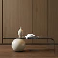 Glass Coffee Table With White Spherical Base And White Vase Stacked Books On Wooden Wall Floor