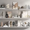 Modern Decorative Ornament Combination On White Shelves With Sculptures Frames Vases And Books