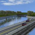 Bridge With Cars Driving Over River Surrounded By Green Trees And Grassy Banks