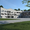 Modern School Building Exterior With Green Lawn Surrounding Trees And Blue Sky
