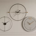 Three Clocks with Different Designs Hanging on White Wall With Decorative Frame