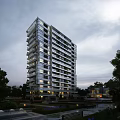 Modern High-Rise Apartment Building with Glass Curtain Walls Night View with Trees and Low-Rise Buildings