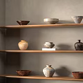 Ceramic Vessels Displayed on Wooden Shelves Against Gray Wall with Rustic Natural Shapes and Colors