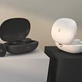 Wireless Headphones with Black and White Charging Cases on Display Stand