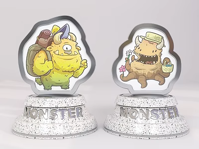 Two Colorful Cartoon Monster Figurines With Silver Speckled Bases Featuring MONSTER Text 3d model