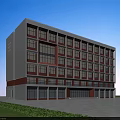 Modern Multistory School Building With White Red Exterior Large Windows And Lawn Under Blue Sky
