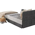 Gray Headboard Children's Bed With Light Colored Mattress And Stuffed Toy Bear