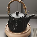 Elegant Black Teapot With Bamboo Handle And Beige Base Including Tea Cups On Bamboo Mat