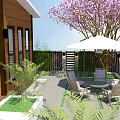 Wooden Vacation Rental Building With Deck Green Plants Outdoor Seating And Pink Flowering Tree