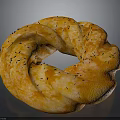 Golden Orange Ring Shaped Bread With Black Sesame Seeds And Twisted Texture