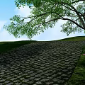 Scenic Cobblestone Road with Green Grass Trees Blue Sky White Clouds and Small Flowers