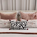 Stylish Decorative Throw Pillows With Pink Velvet Black White Patterns And Pom Poms On Bed