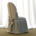 Elegant Beige Dining Chair With Tufted Back Bow Detail And Skirt Against White Curtains Background