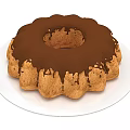 Moist Bundt Cake Topped With Chocolate Glaze Served On White Plate