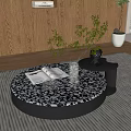 Round Coffee Table With Black And White Patterned Top Open Book Transparent Vase Green Plant