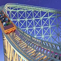 Roller Coaster Ride with Curved Track and Lattice Structure under Night Sky with Passengers