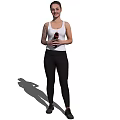 Woman Standing In White Tank Top And Black Leggings Holding Black Bottle Against White Background