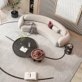 Curved Beige Sofa and Black Coffee Table Set with Armchair Floor Lamp and Plant on Rug