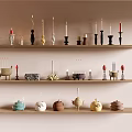Various Decorative Candles and Unique Candle Holders Displayed on Wooden Shelves