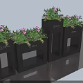 Black Garden Planters With Pink Flowering Plants And Brand Logo Decor