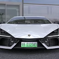 White Lamborghini Sports Car With Sleek Design Sharp Front Black Wheels And Green License Plate