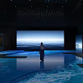 Open Interactive Zone With Standing Person Large Screen Ocean View And Reflective Floor
