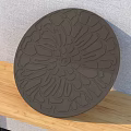 Artistic Intricate Dark Brown Circular Carved Design For Home Decor On Wooden Surface