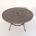 Outdoor Metal Circular Table With Decorative Pattern And Ornate Iron Base For Garden Patio Use