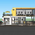 Two Story Yellow And White Container Building Café With Outdoor Seating Trees And Tables