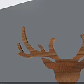 Wooden Deer Head Decoration With Natural Wood Grain On Light Colored Wall And Smooth Countertop